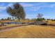 Picturesque golf course view with a charming bridge over a pond, surrounded by lush landscaping at 4937 S Peach Willow Ln, Gilbert, AZ 85298