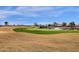 Scenic golf course view featuring a pond with a fountain and manicured green at 4937 S Peach Willow Ln, Gilbert, AZ 85298