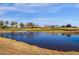 Stunning golf course views featuring a pond with a fountain and clubhouse in the background at 4937 S Peach Willow Ln, Gilbert, AZ 85298