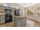 Modern kitchen featuring stainless steel appliances, granite countertops, and plenty of cabinet space at 4937 S Peach Willow Ln, Gilbert, AZ 85298