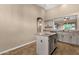 Bright kitchen featuring granite countertops, gray cabinets, and a center island for extra space at 4937 S Peach Willow Ln, Gilbert, AZ 85298