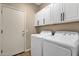 Laundry room featuring a washer and dryer, with extra storage at 4937 S Peach Willow Ln, Gilbert, AZ 85298