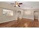 Bright living room featuring hardwood floors, neutral paint and an open view to the dining area at 4937 S Peach Willow Ln, Gilbert, AZ 85298