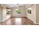 Spacious living room featuring hardwood floors, ceiling fan, and views of the backyard at 4937 S Peach Willow Ln, Gilbert, AZ 85298