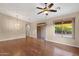 Bright living room featuring hardwood floors, modern ceiling fan, and access to the backyard at 4937 S Peach Willow Ln, Gilbert, AZ 85298