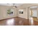 Open-concept living room with hardwood floors, natural light, and an open view to the kitchen at 4937 S Peach Willow Ln, Gilbert, AZ 85298
