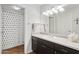 Well-maintained bathroom with a vanity, a shower with a black and white curtain, and ample lighting at 5303 N 7Th St # 215, Phoenix, AZ 85014