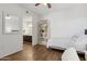 Cozy bedroom with wood floors, a comfortable bed, and convenient access to the ensuite bathroom at 5303 N 7Th St # 215, Phoenix, AZ 85014