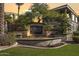 Entrance to The Carlyle Condominium with a beautifully landscaped sign and mature trees at 5303 N 7Th St # 215, Phoenix, AZ 85014
