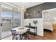 Bright dining area featuring a chandelier, access to a balcony, and stylish decor at 5303 N 7Th St # 215, Phoenix, AZ 85014