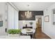 Chic dining area with a chandelier, white table, and dark accent wall creating a stylish ambiance at 5303 N 7Th St # 215, Phoenix, AZ 85014