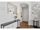 Inviting entryway featuring a mirror, stylish console table, and hardwood floors at 5303 N 7Th St # 215, Phoenix, AZ 85014