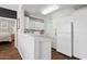 Bright kitchen featuring white cabinets, modern appliances, and an open layout with wood floors at 5303 N 7Th St # 215, Phoenix, AZ 85014