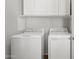 Functional laundry room equipped with a washer, dryer, and convenient overhead storage at 5303 N 7Th St # 215, Phoenix, AZ 85014