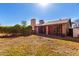 A wide backyard featuring a covered patio, low maintenance landscaping, and a chimney at 5710 W Evergreen Rd, Glendale, AZ 85302