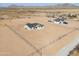 An aerial view of a single Gathering home with a dark roof, and a huge dirt front and back yard at 57856 W Fulcar Rd, Maricopa, AZ 85139