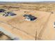 An aerial view of a single Gathering home with a dark roof, and a huge dirt front and back yard at 57856 W Fulcar Rd, Maricopa, AZ 85139
