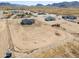 Expansive aerial view of a desert property featuring a newly constructed home and large fenced lot at 57856 W Fulcar Rd, Maricopa, AZ 85139