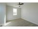 Neutral bedroom featuring carpet, a ceiling fan and a bright window at 57856 W Fulcar Rd, Maricopa, AZ 85139