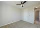 Bedroom featuring carpet, a ceiling fan and a door to the hallway at 57856 W Fulcar Rd, Maricopa, AZ 85139