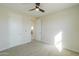 Bright bedroom featuring neutral carpet, ceiling fan, and two closets for ample storage at 57856 W Fulcar Rd, Maricopa, AZ 85139