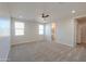 Spacious bedroom features neutral carpet, recessed lights, and large windows for abundant natural light at 57856 W Fulcar Rd, Maricopa, AZ 85139