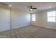 This bedroom features neutral carpet, natural light, and creates a relaxing atmosphere at 57856 W Fulcar Rd, Maricopa, AZ 85139