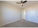 Neutral bedroom featuring carpet, a closet and a ceiling fan at 57856 W Fulcar Rd, Maricopa, AZ 85139