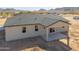 An exterior view showcasing a newly constructed home with a covered patio and desert landscaping at 57856 W Fulcar Rd, Maricopa, AZ 85139
