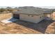 View of home and garage featuring desert landscape, modern roll-up door, and concrete driveway at 57856 W Fulcar Rd, Maricopa, AZ 85139