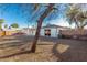 Backyard features low-maintenance gravel, brick perimeter, and a shade tree to create an inviting outdoor space at 638 W 16Th St, Tempe, AZ 85281