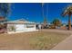 Side view of a white single-story home featuring a white roof and palm trees at 638 W 16Th St, Tempe, AZ 85281