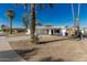 Front exterior of white single-story home featuring a covered parking area and palm trees at 638 W 16Th St, Tempe, AZ 85281