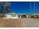 Charming single-story white home featuring a covered parking area and tall palm trees at 638 W 16Th St, Tempe, AZ 85281