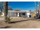 Front exterior of white single-story home featuring a covered parking area and palm trees at 638 W 16Th St, Tempe, AZ 85281