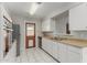 Functional kitchen offers white cabinets, stainless steel dishwasher, and tiled floors at 638 W 16Th St, Tempe, AZ 85281