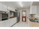 Well-lit kitchen boasting white cabinets, stainless steel refrigerator, and tiled floors at 638 W 16Th St, Tempe, AZ 85281