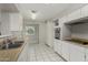 Kitchen featuring white cabinets, double basin sink, and white tile floors at 638 W 16Th St, Tempe, AZ 85281