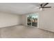 Bright living room boasting plush carpet floors, a ceiling fan, and glass sliding doors at 638 W 16Th St, Tempe, AZ 85281