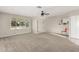 Open-concept living room with neutral carpet, ceiling fan, and bright natural light at 638 W 16Th St, Tempe, AZ 85281
