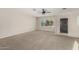 Spacious living room with neutral carpet, ceiling fan, and bright natural light at 638 W 16Th St, Tempe, AZ 85281