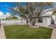 Backyard with lush artificial grass, a mature tree, and a charming patio area at 6926 E Moreland St, Scottsdale, AZ 85257