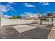 Backyard features gravel, concrete pads, and mature tree, all within a fenced boundary at 6926 E Moreland St, Scottsdale, AZ 85257