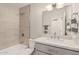 Updated bathroom featuring a tub, sleek vanity, and neutral tile in a bright, modern space at 6926 E Moreland St, Scottsdale, AZ 85257