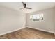 Bedroom featuring a ceiling fan, a large window, and wood-look floors at 6926 E Moreland St, Scottsdale, AZ 85257