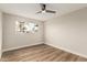 Bright bedroom features a large window, ceiling fan, and wood-look floors at 6926 E Moreland St, Scottsdale, AZ 85257