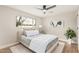 Cozy bedroom features a ceiling fan, a comfortable bed, and a view to the outside at 6926 E Moreland St, Scottsdale, AZ 85257