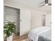 Bright bedroom featuring a ceiling fan, sliding closet doors, and wood-look floors at 6926 E Moreland St, Scottsdale, AZ 85257