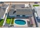 Aerial view of backyard with pool, backyard, putting green, and covered patio at 7014 E Latham St, Scottsdale, AZ 85257