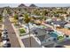 View of multiple residential homes, palm trees, and desert mountains at 7014 E Latham St, Scottsdale, AZ 85257
